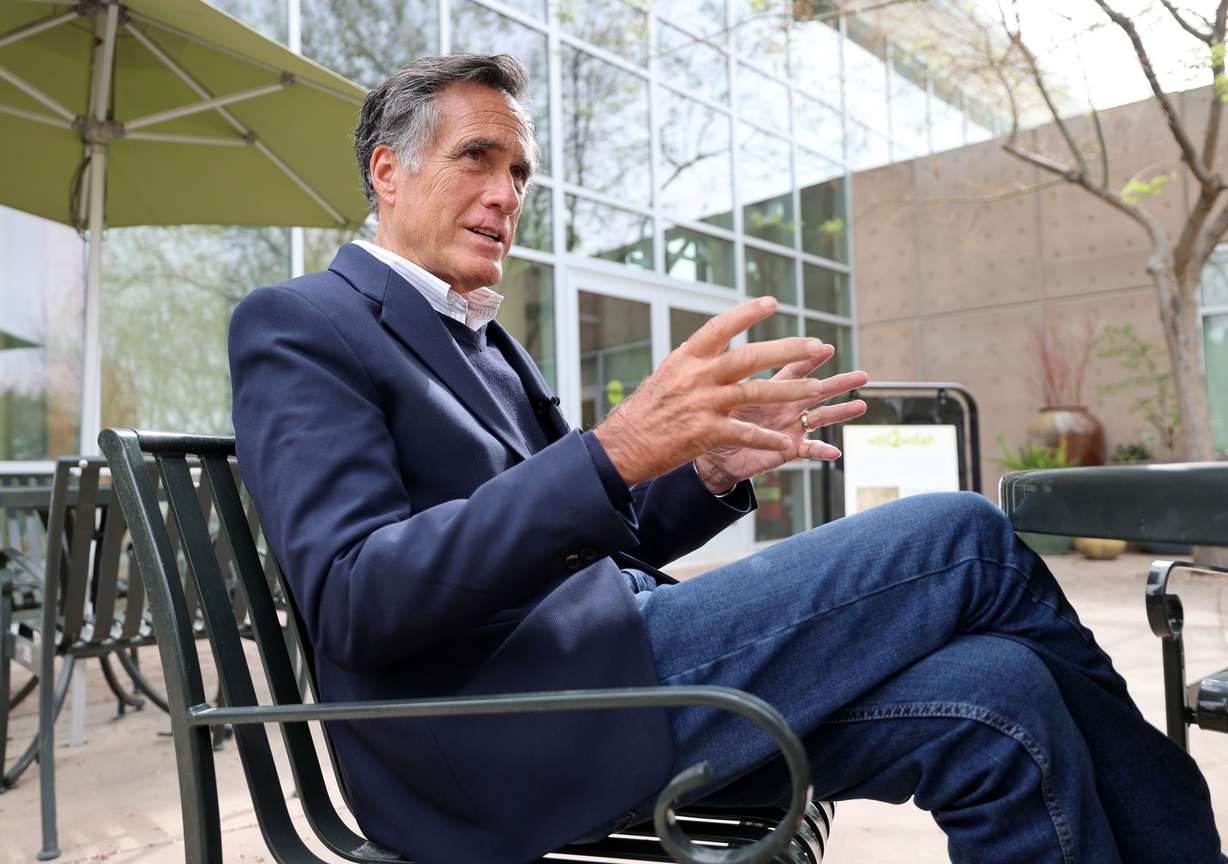 Sen. Mitt Romney, R-Utah, talks to members of the media after a roundtable discussion about the Jor...