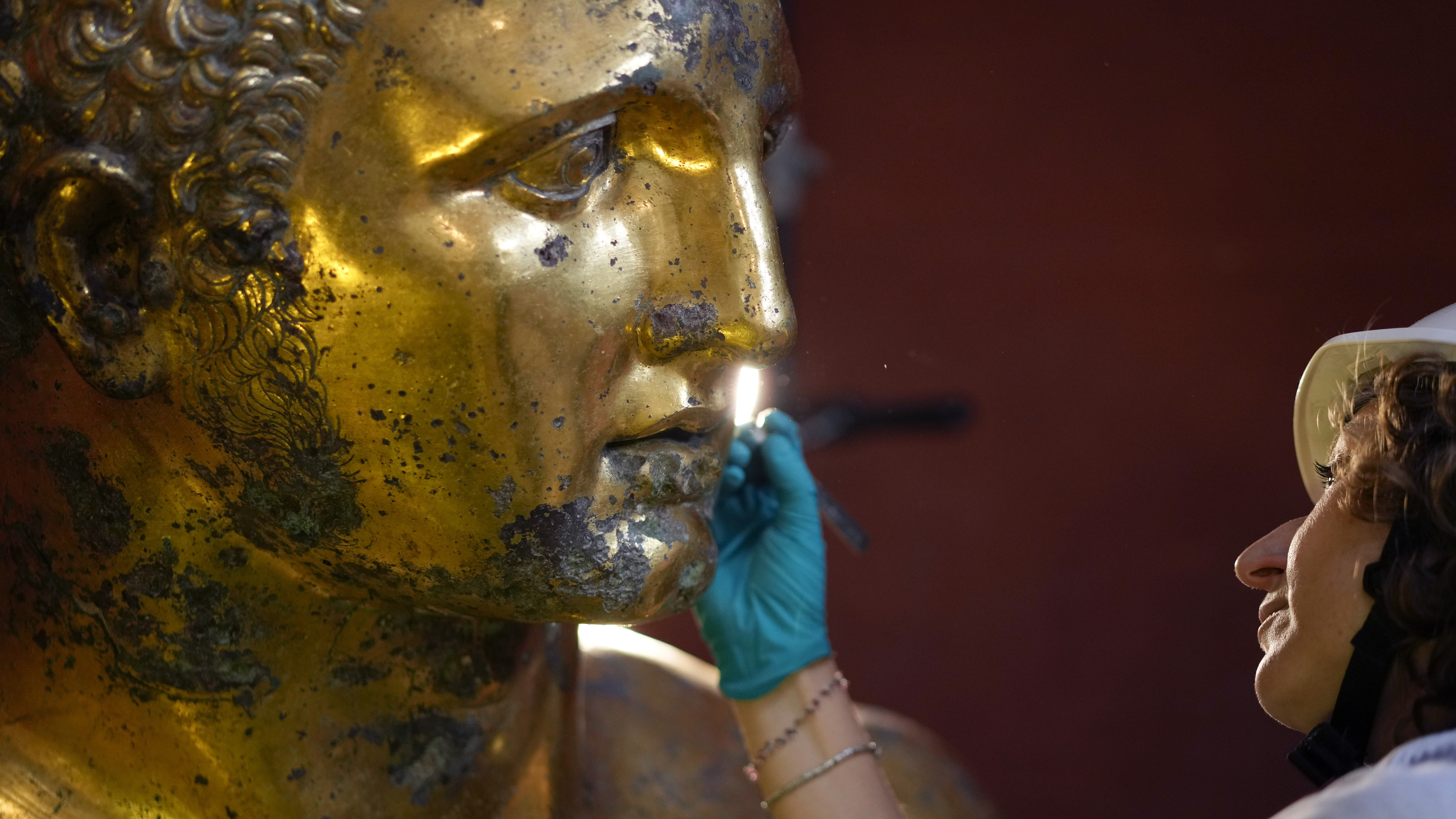 Vatican Museum restorer Alice Baltera works on the bronze Hercules statue, in the Round Hall of the...