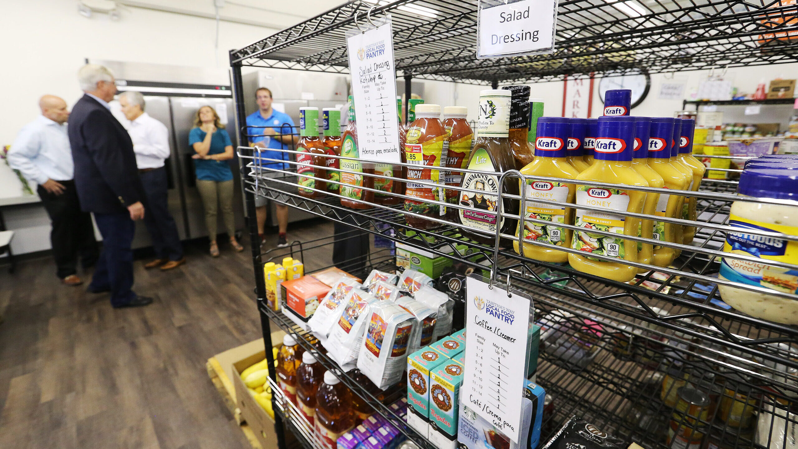 Guests look over items during the opening of Tabitha’s Way Local Food Pantry in American Fork on ...
